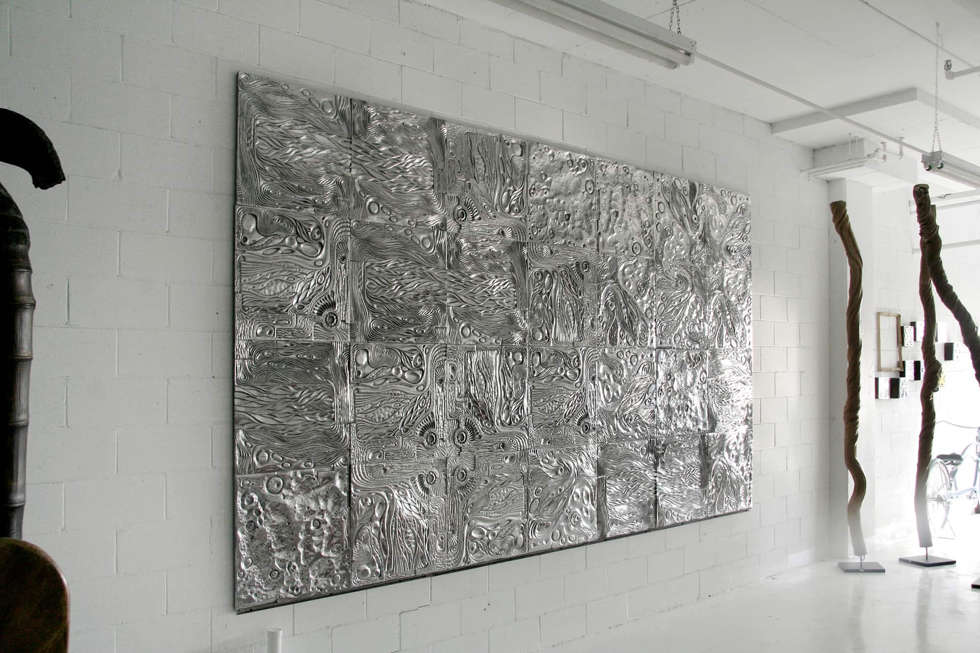 sand-casted and hand-polished recycled aluminium mural work
